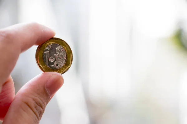 Business man hold one dollar singapore with blurred background