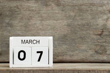 Mevcut Tarih 7 ve ay Mart ahşap arka plan üzerinde beyaz blok takvim