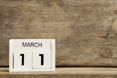 Mevcut tarih 11 ve ay Mart ahşap arka plan üzerinde beyaz blok takvim