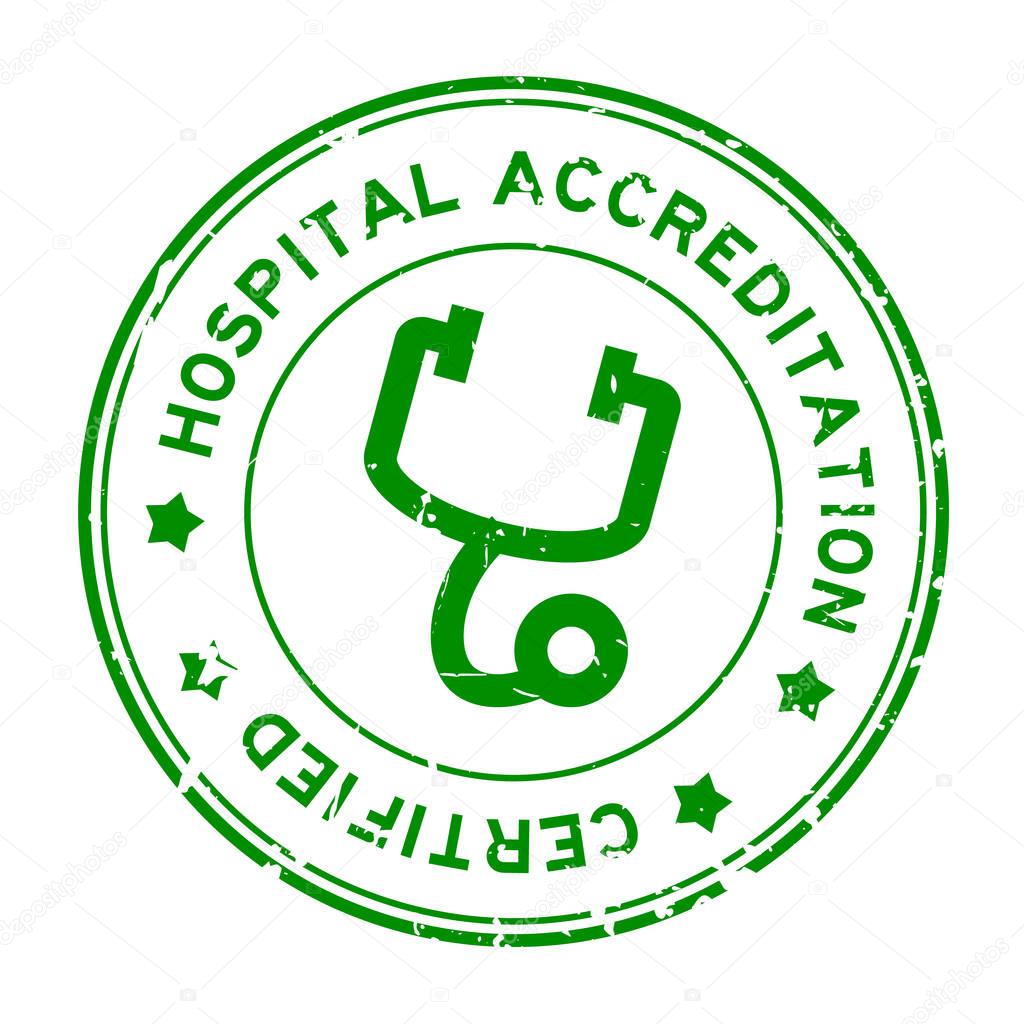Grunge green hospital accreditation with stethoscope icon round rubber seal stamp on white background