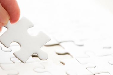 Arka plan beyaz düz jigsaw maç veya yerine getirmek için eksik parçası tutan el ile kapalı