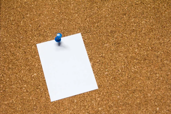 Blank white paper pin on cork board background for remind, to do list or news bulletin