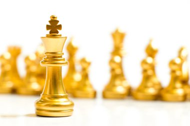 Altın Kral satranç parça standı önünde beyaz arka plan (kavramı liderlik, yönetim ekibi)