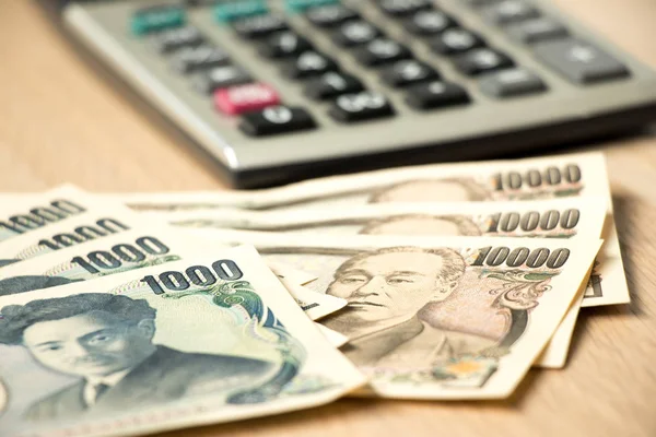 Japoński Jen banknotów i Kalkulator na drewno stół tło — Zdjęcie stockowe