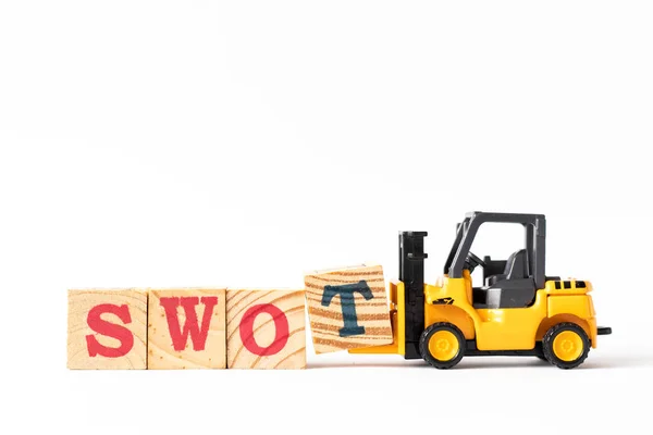 Toy forklift hold wood letter block t to complete word swot (abbreviation of strength, weakness, opportunities, threats) on white background — ストック写真