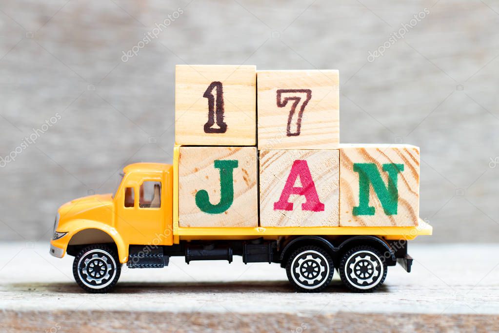 Truck hold letter block in word 17jan on wood background (Concept for date 17 month January)
