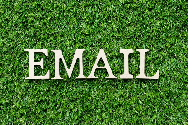 Litera alfabetu drewna w wiadomości e-mail słowo na zielonym tle trawy — Zdjęcie stockowe
