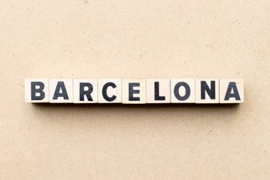 Alphabet letter block in word barcelona on wood background
