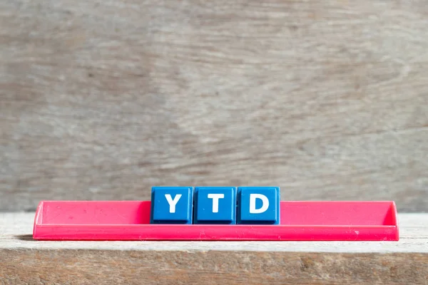 Tile letter on red rack in word YTD (abbreviation of year to date) on wood background — 스톡 사진