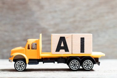 Truck hold letter block in word AI (Abbreviation of artificial intelligence) on wood background