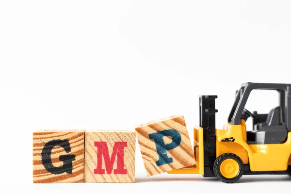 Toy forklift hold wood letter block P to complete word GMP (Abbreviation of Good Manufacturing Practice) on white background — ストック写真