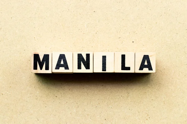 Letter block in word Manila on wood background — Stockfoto