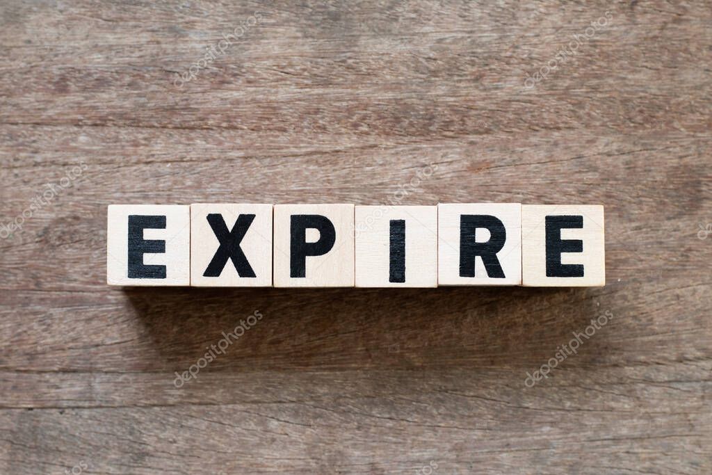 Letter block in word expire on wood background