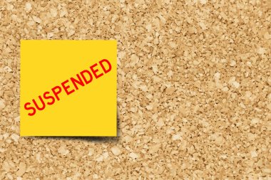 Yellow note with word suspended on cork board background  with copy space (Vector) clipart