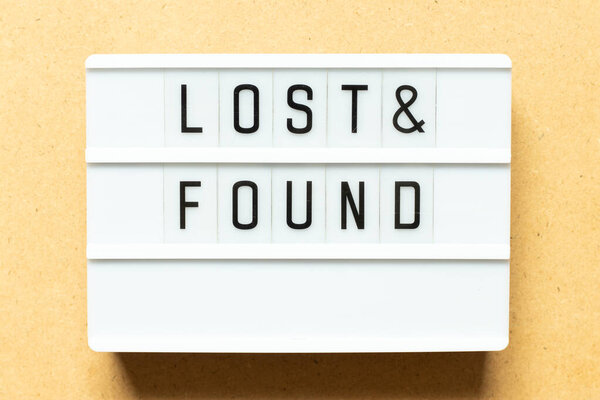 Lightbox with word lost & found on wood background