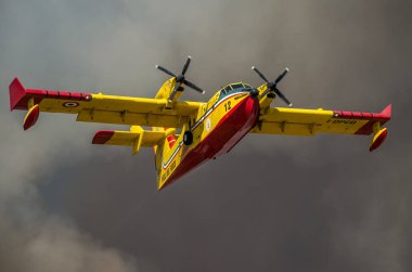 ROMA, ITALY - JULY 2017: Firefighting aircraft Bombardier CL-415 in an emergency situation, during a natural disaster, gathers water in the sea to extinguish a fire and eliminate catastrophe in Ostia clipart