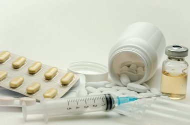 İlaçlar, vitaminler ve enjeksiyon için şırınga beyaz arka planda izole edilmiş ilaçlar