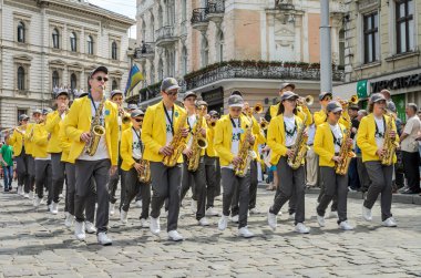 Lviv, Ukrayna - 2018 olabilir: Bando trompet ve saksafon arıları ile karnaval kostümleri ile bir geçit şehir merkezinde boyunca yürüyor