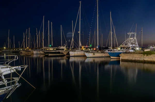 Night port with luxury sailing yachts