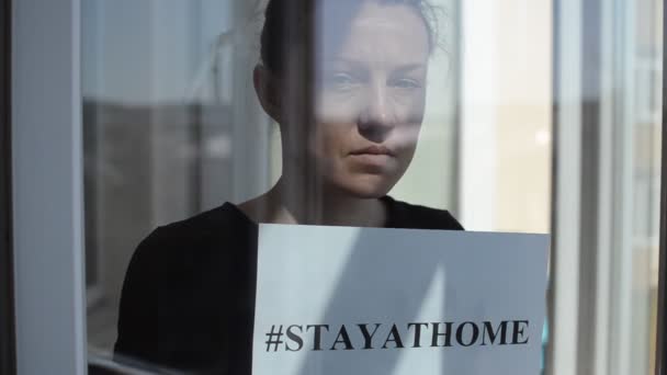 Young Girl Stands Window Sign Saying Stayathome — Stock Video