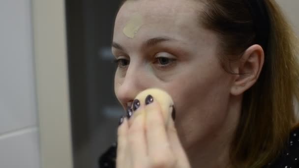 Young Woman Puts Foundation Her Face Mirror — Stock Video