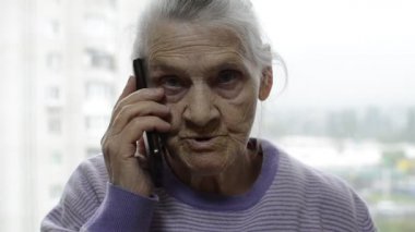 Akıllı telefondan konuşan yaşlı bir kadın.