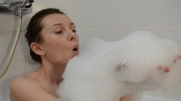 Young Charming Girl Bathes Bathtub Foam Blows Foam Blowing Bubbles — Stock Video