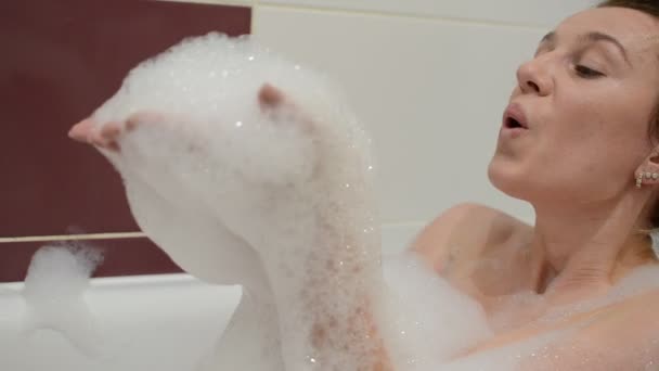 Young Charming Girl Bathes Bathtub Foam Blows Foam Blowing Bubbles — Stock Video