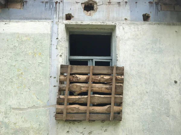 old window with pallet in grungy building