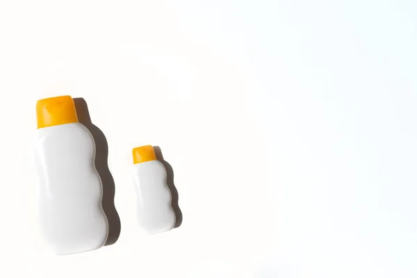 Two bottles of sunscreen on a white background — Stock Photo, Image