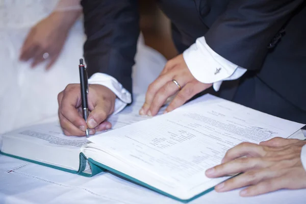 Groom signs wedding deed in Christian marriage — Stock Photo, Image