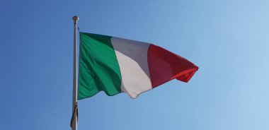 Italian tricolor flag waving on sunny day