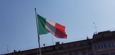 Italian tricolor flag waving on sunny day