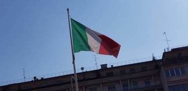 Italian tricolor flag waving on sunny day