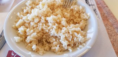 white rice on plate in canteen with oil and cheese