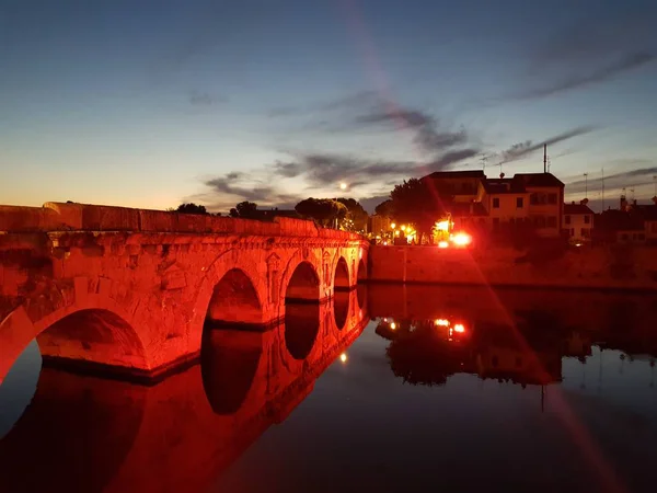 rimini by night ancient bridge with lake reflect