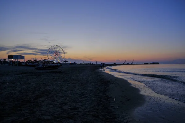 Rini plajı, parlak renkleri ve deniz panoramik tekerleği olan güzel bir gün batımı. — Stok fotoğraf