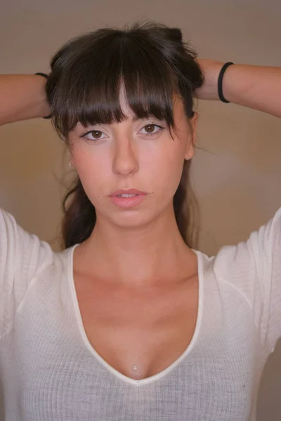Retrato de bela menina de cabelos escuros com cabelo longo de corte baixo e t-shirt branca na foto a cores — Fotografia de Stock