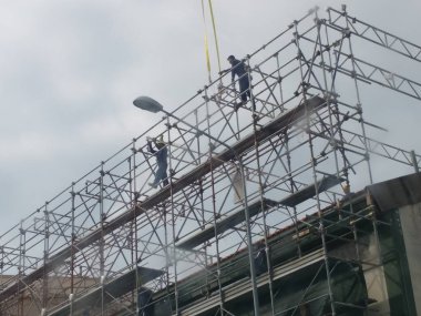 İskele iskelesinde çalışan adamlar.