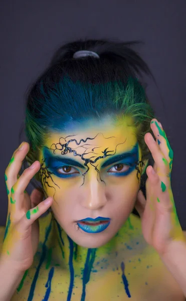color face paiting bodypainting model with demons blue yelllow green