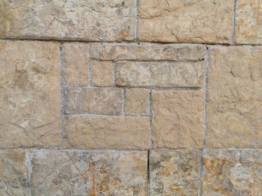 Güneşli bir günde eski taş duvar ve tuğla desenli arka plan