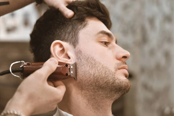 Shave beards in barbercos. A beautiful guy shaves a beard. Body care.