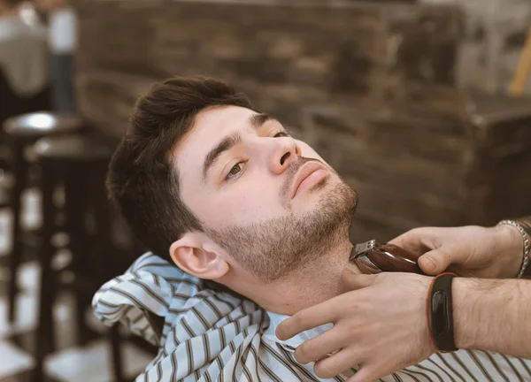 Shave beards in barbercos. A beautiful guy shaves a beard. Body care.