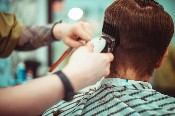 Men's haircut in barbershop. Hair care. Tinted photo. Soft focus. — Stock Photo, Image
