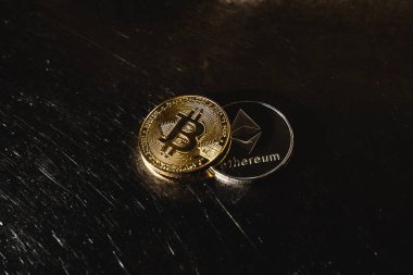Karanlık bir arka planda Bitcoin. Ethereum ve bitcoin fiyatları yükseliyor ve düşüyor. 