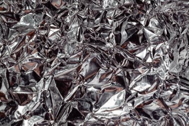 Folyo dokusu. Gümüş desenli yakın plan fotoğraf. Metal arkaplan