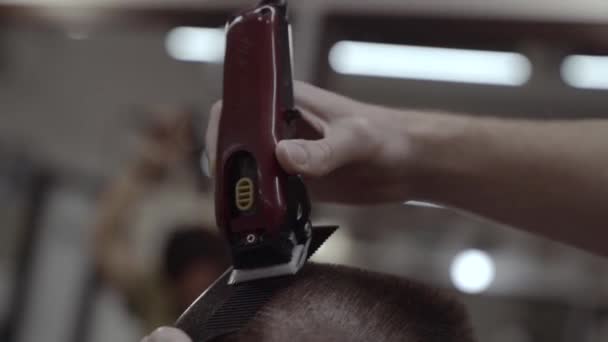 Hajvágás elektromos borotva. Férfi fodrász egy fodrászatban. — Stock videók