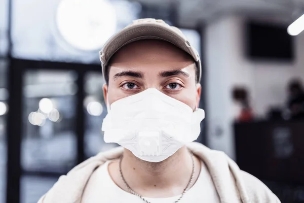 A man puts on a mask from a virus. Flu epidemic.