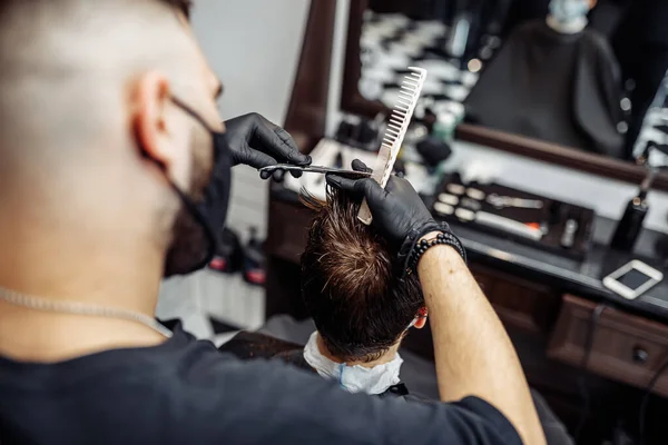 Criando um corte de cabelo fresco e estilo em uma barbearia . — Fotografia de Stock