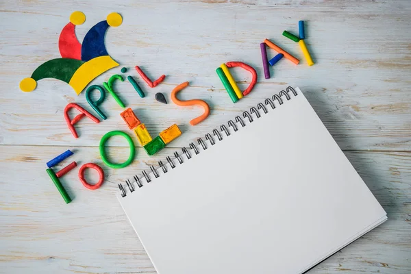 April Fools Day text made with plasticine and free space in note — Stock Photo, Image
